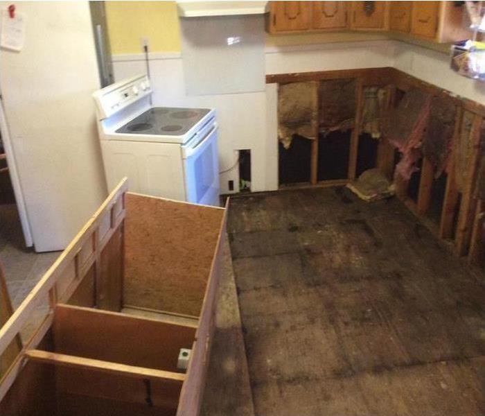 removed cabinets, voids open showing studs, subfloor of sheathing