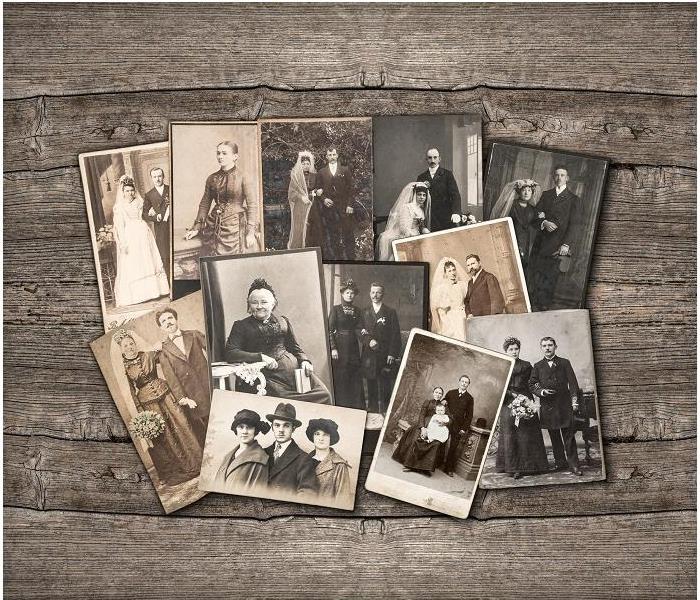 collection of vintage photos resting on board
