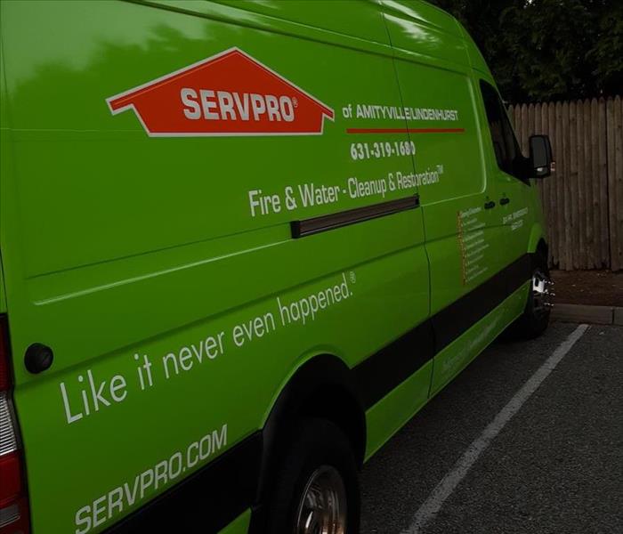 SERVPRO vehicle and equipment outside job site.
