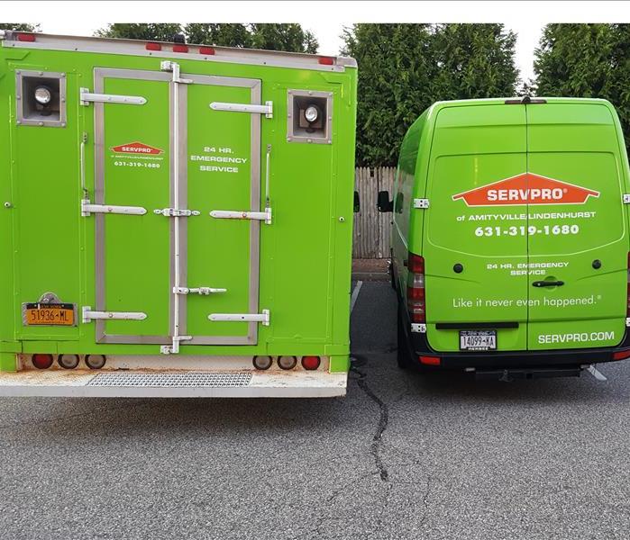 SERVPRO Green Vehicles Parked and on the Job